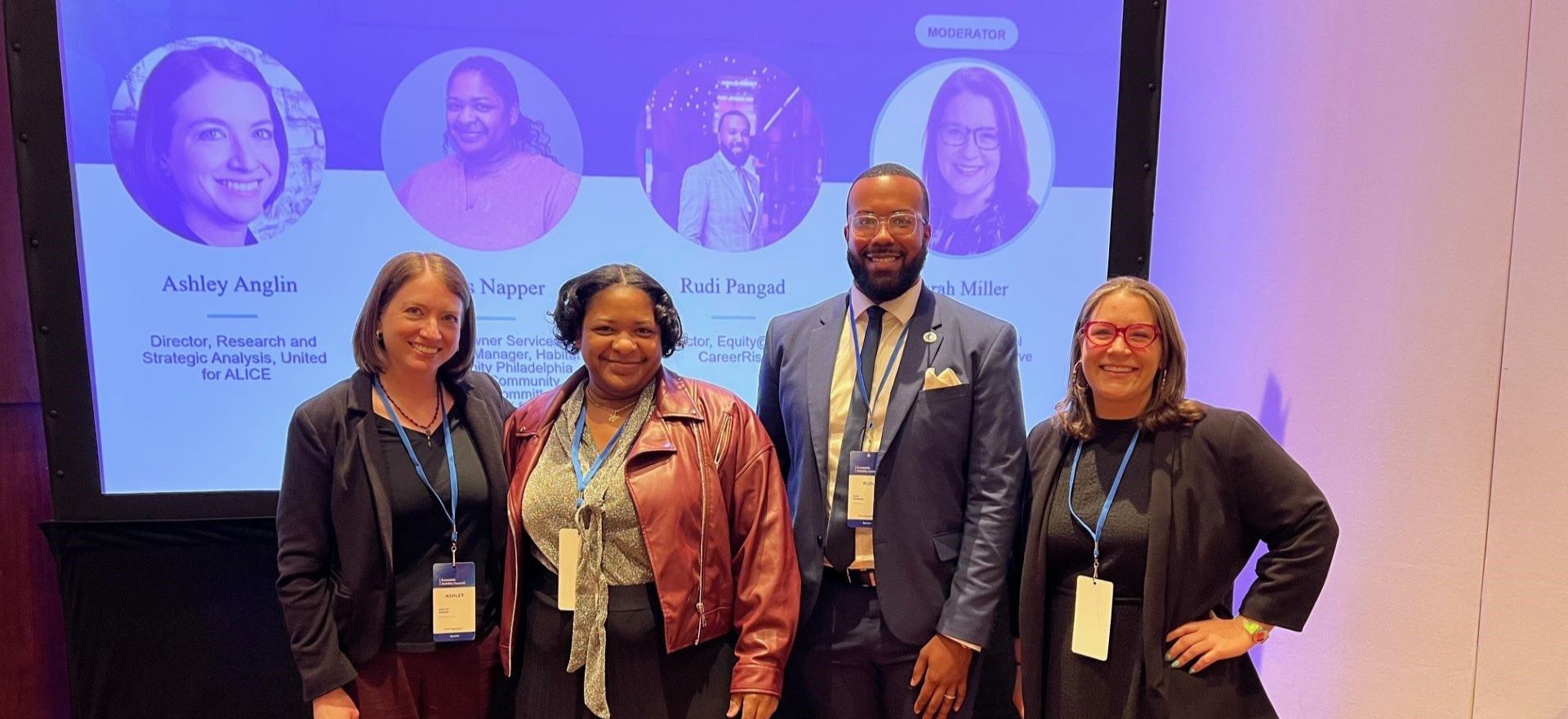 Ashley Anglin of United For ALICE stands and smiles with her panel at the Federal Reserve Bank of Philadelphia's Economic Mobility Summit
